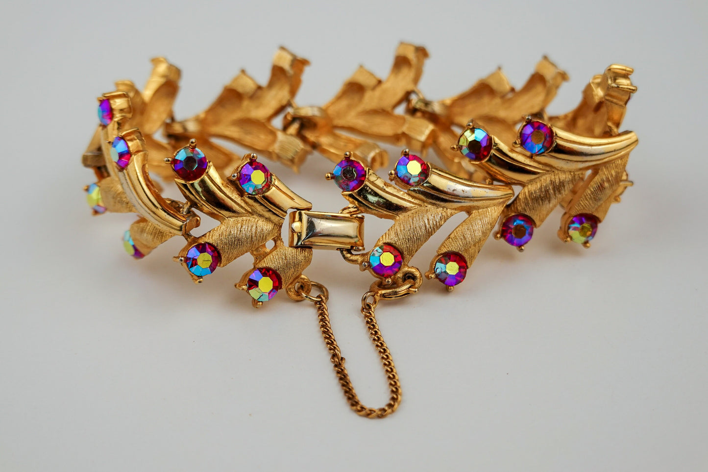 Vintage Puccini Raspberry Aurora Borealis Rhinestone Bracelet - Gold Tone Articulated Fancy Link, Leaf Motif - Mid-Century Bracelet
